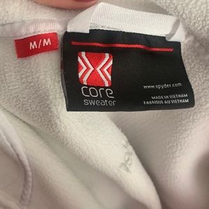 Women’s size medium Spyder full zip ribbed jacket in White. Never worn, no tags.